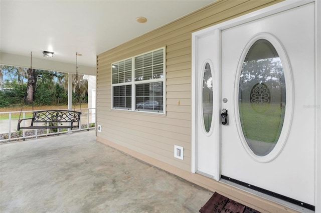 entrance to property featuring covered porch