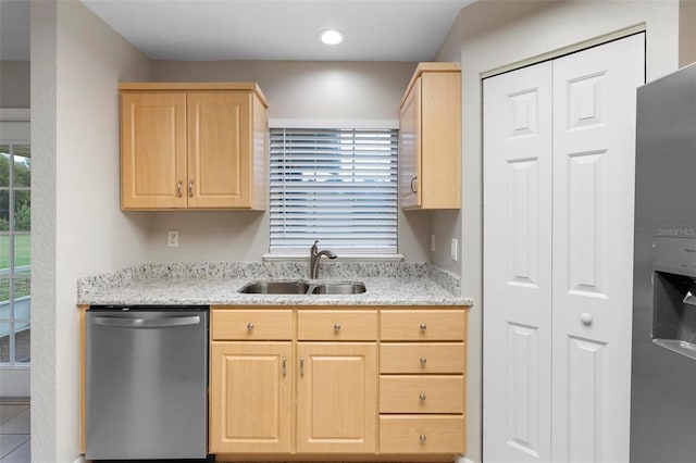 kitchen featuring recessed lighting, appliances with stainless steel finishes, light brown cabinets, a sink, and light stone countertops