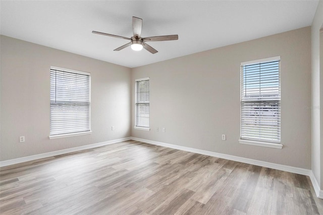 unfurnished room featuring baseboards, ceiling fan, and light wood finished floors