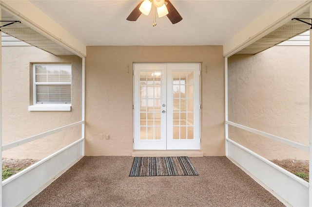 property entrance with a ceiling fan and french doors