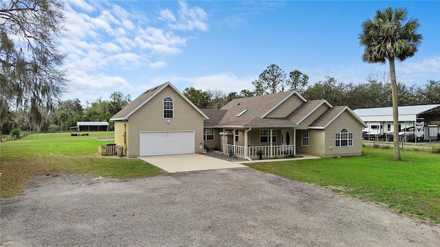 view of front of house with a garage, driveway, a porch, and a front yard