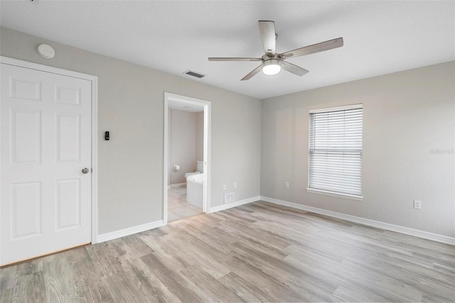 unfurnished bedroom with light wood finished floors, visible vents, and baseboards