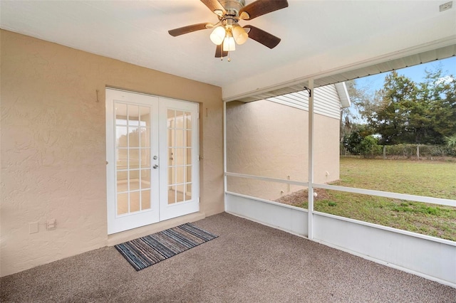 unfurnished sunroom with ceiling fan, a wealth of natural light, and french doors