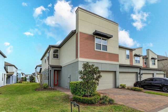 view of front of property with a garage, driveway, a residential view, a front lawn, and stucco siding