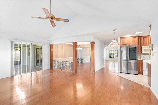 kitchen featuring brown cabinets, light countertops, light wood-type flooring, white appliances, and ornate columns