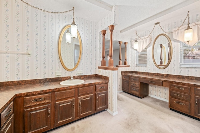 bathroom with lofted ceiling, wallpapered walls, and vanity