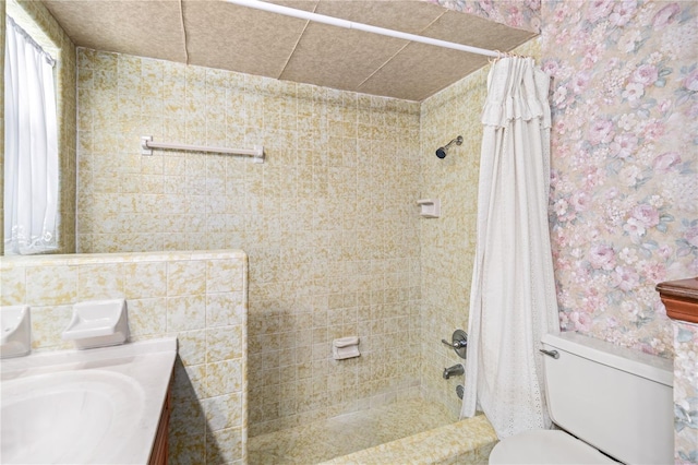 full bath with wallpapered walls, vanity, toilet, and shower / tub combo with curtain