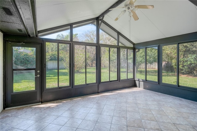 unfurnished sunroom featuring vaulted ceiling with beams and ceiling fan