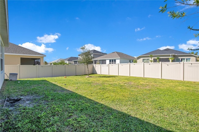 view of yard with a fenced backyard and a residential view