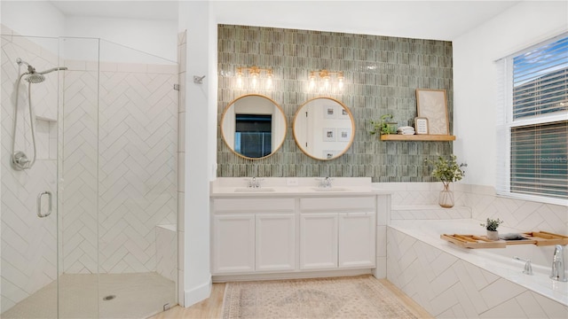 bathroom with a sink, a stall shower, double vanity, and a bath