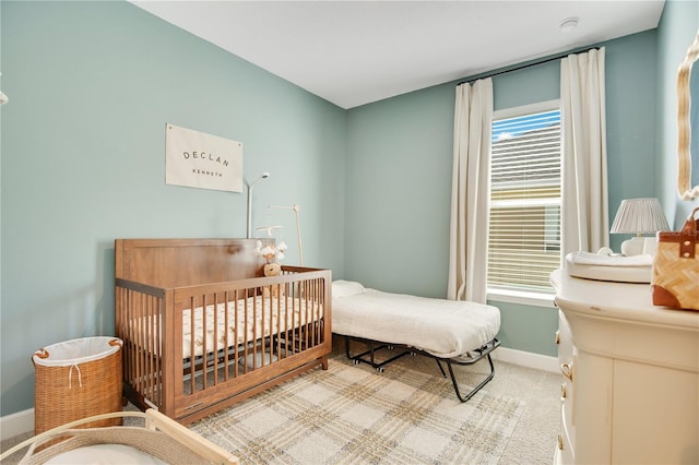 bedroom featuring baseboards and carpet