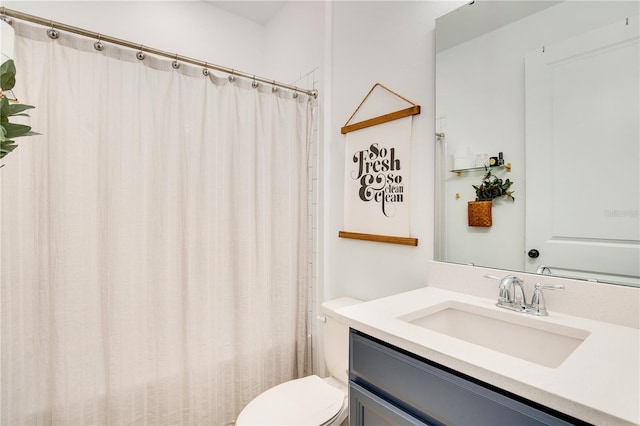 bathroom featuring vanity, a shower with shower curtain, and toilet