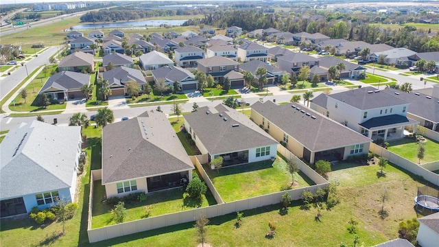 drone / aerial view with a residential view and a water view