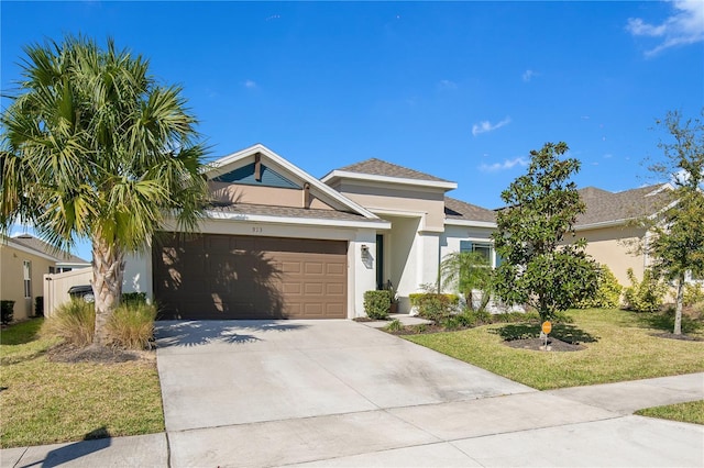 view of front facade featuring a front yard, a shingled roof, stucco siding, concrete driveway, and a garage