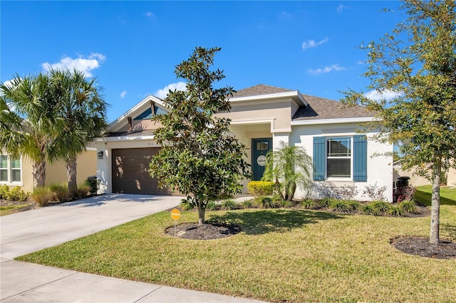 view of front of home featuring stucco siding, a front yard, concrete driveway, and an attached garage