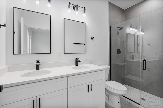 bathroom featuring a stall shower, a sink, and toilet