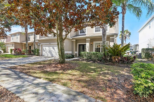 view of front of property with a garage, driveway, and stucco siding