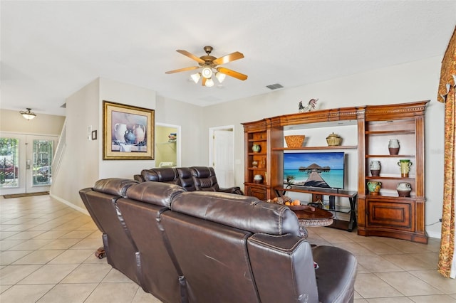 living room featuring light tile patterned floors, baseboards, visible vents, a ceiling fan, and french doors