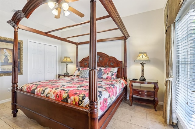 bedroom featuring tile patterned flooring, multiple windows, and a closet