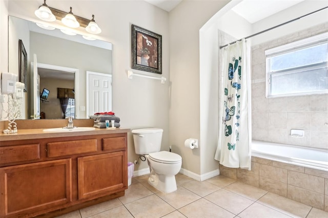 bathroom with tiled shower / bath combo, vanity, toilet, and tile patterned floors