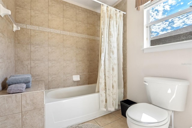 bathroom featuring toilet, shower / bath combo with shower curtain, and tile patterned floors