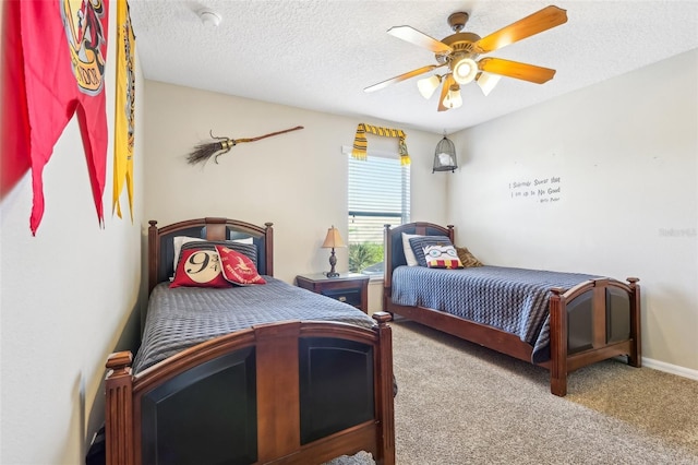 bedroom featuring baseboards, carpet, a ceiling fan, and a textured ceiling