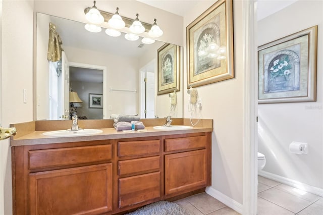 full bath with double vanity, tile patterned flooring, a sink, and toilet