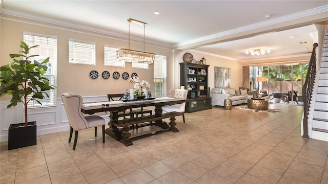 dining space featuring light tile patterned floors, ornamental molding, a decorative wall, and a wainscoted wall