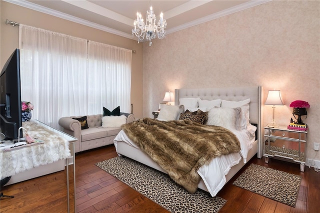 bedroom featuring ornamental molding, a raised ceiling, a notable chandelier, and hardwood / wood-style flooring