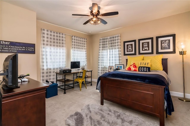 carpeted bedroom featuring a ceiling fan and baseboards