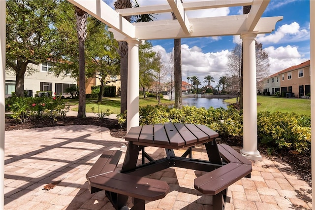 view of patio / terrace with a water view and a pergola