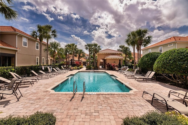 pool featuring a patio area and fence