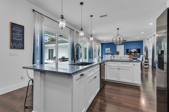 kitchen featuring a sink, visible vents, open floor plan, stainless steel fridge with ice dispenser, and dark wood finished floors