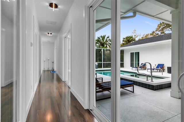 hallway with dark wood-style floors and baseboards