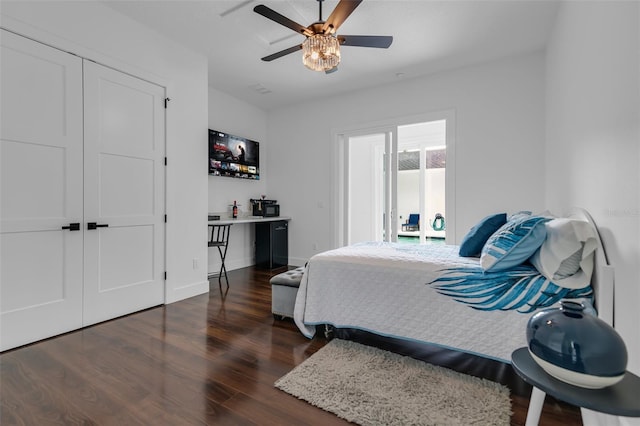 bedroom featuring wood finished floors, a ceiling fan, and baseboards