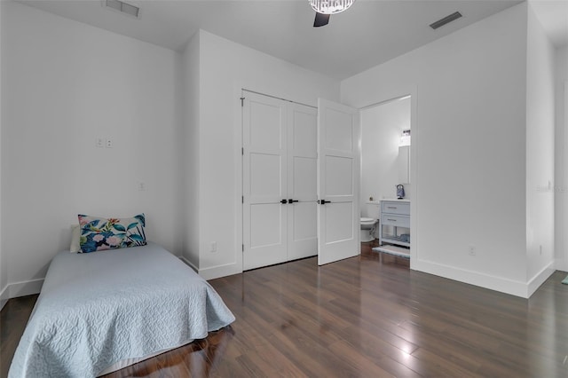 bedroom with baseboards, a closet, visible vents, and wood finished floors