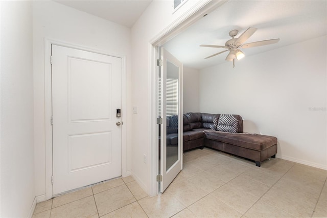 foyer entrance featuring ceiling fan, light tile patterned floors, visible vents, and baseboards