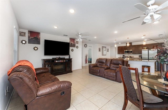 living room featuring light tile patterned floors, ceiling fan, visible vents, and recessed lighting