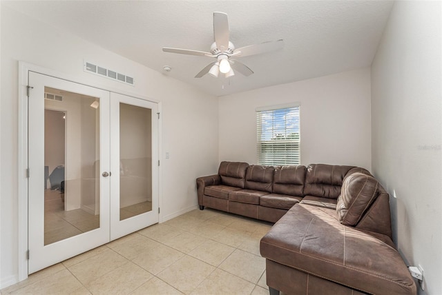 living room featuring french doors, visible vents, and light tile patterned floors