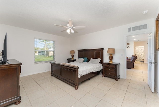 bedroom with visible vents, a ceiling fan, light tile patterned flooring, a textured ceiling, and baseboards