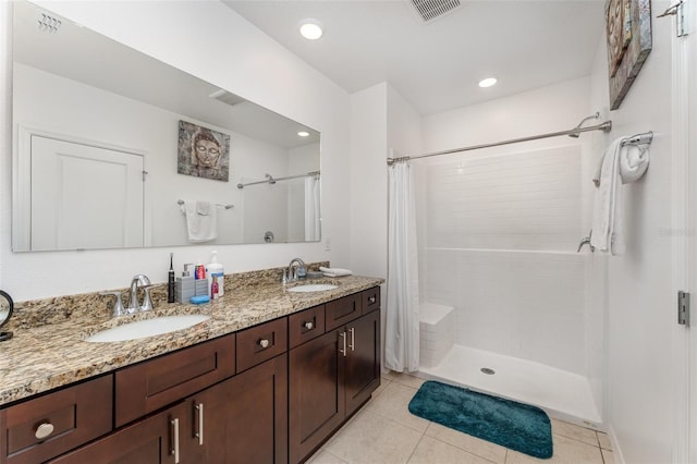 full bath featuring visible vents, a sink, and tiled shower