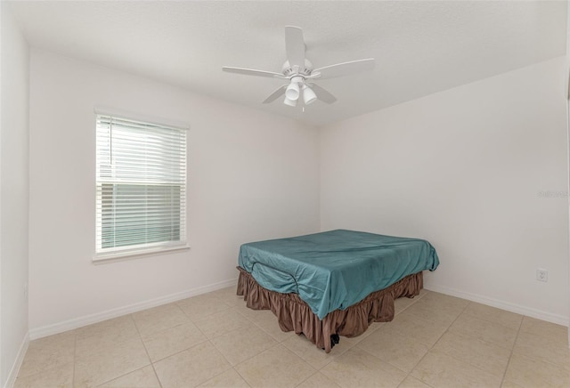 bedroom featuring tile patterned flooring, ceiling fan, and baseboards