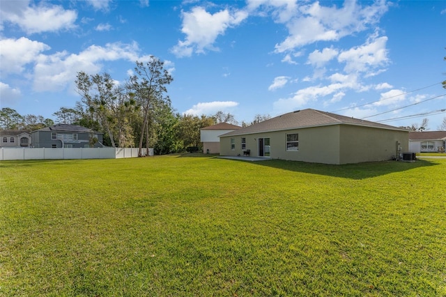 view of yard with a patio area, fence, and cooling unit