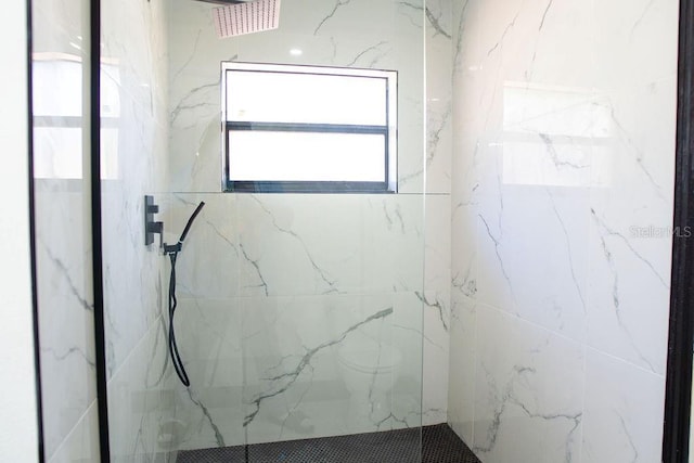 bathroom with a marble finish shower