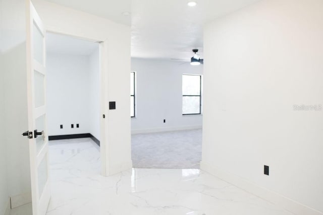 spare room featuring ceiling fan, marble finish floor, recessed lighting, and baseboards