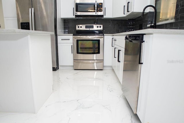 kitchen with stainless steel appliances, marble finish floor, white cabinetry, and tasteful backsplash