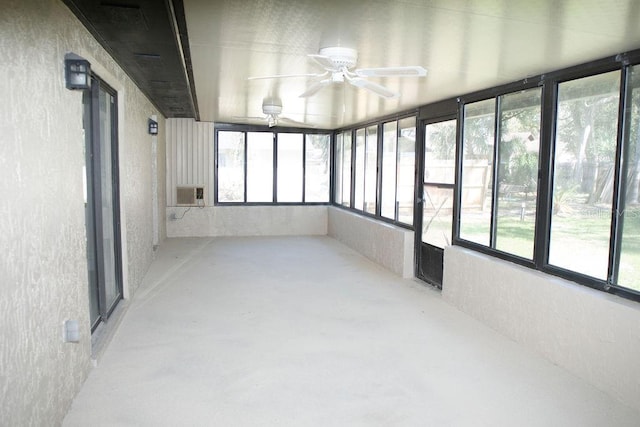 unfurnished sunroom with a ceiling fan