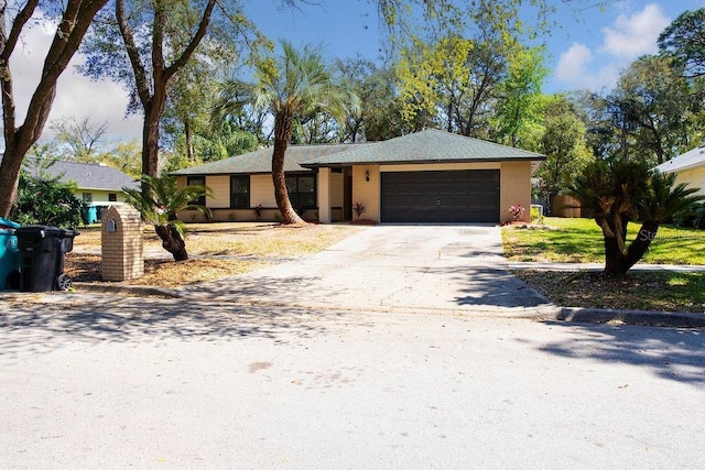 view of front facade with a garage, concrete driveway, and brick siding