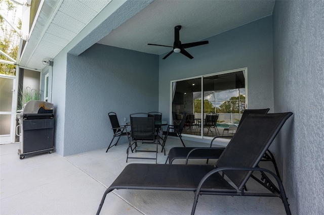 view of patio / terrace with a lanai, a grill, outdoor dining area, and a ceiling fan