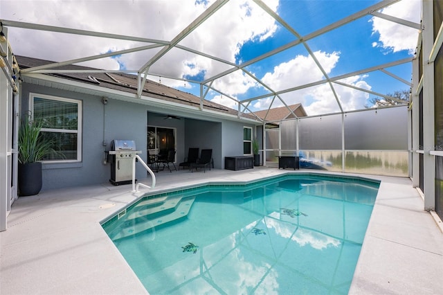 outdoor pool with glass enclosure, a patio, grilling area, and ceiling fan